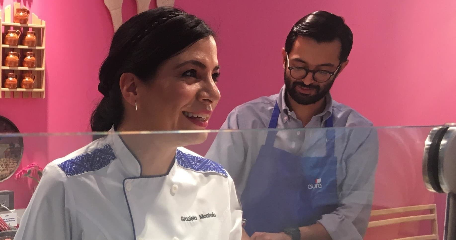 Smiling instructors in pink kitchen teaching traditional Mexican recipes