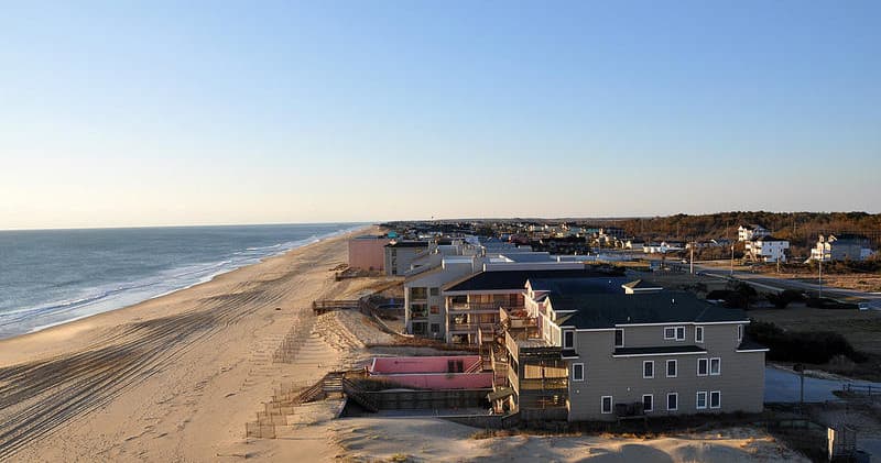 Aerial view of wide sandy beach and coastal homes