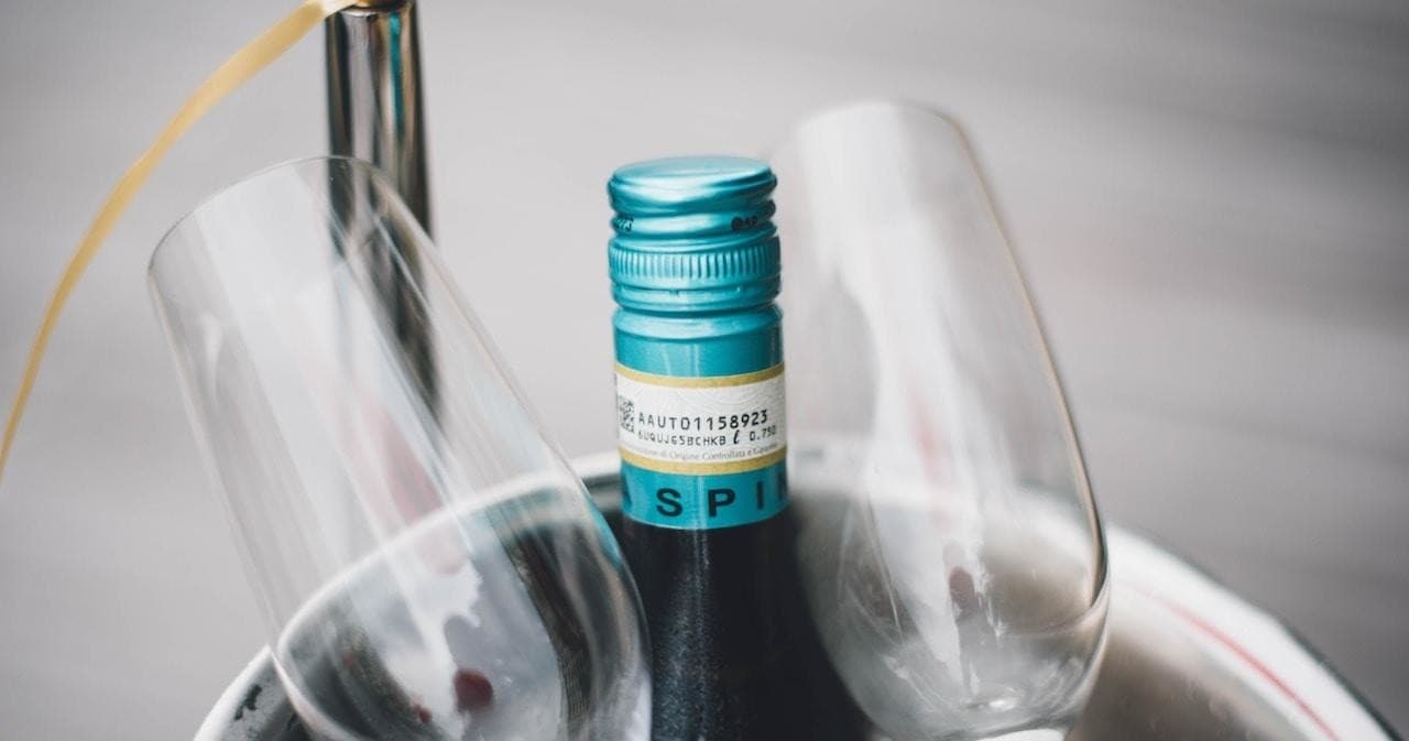 Close-up of chilled wine bottle and glasses at elegant table