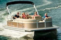 Family cruising on pontoon boat across choppy lake waters