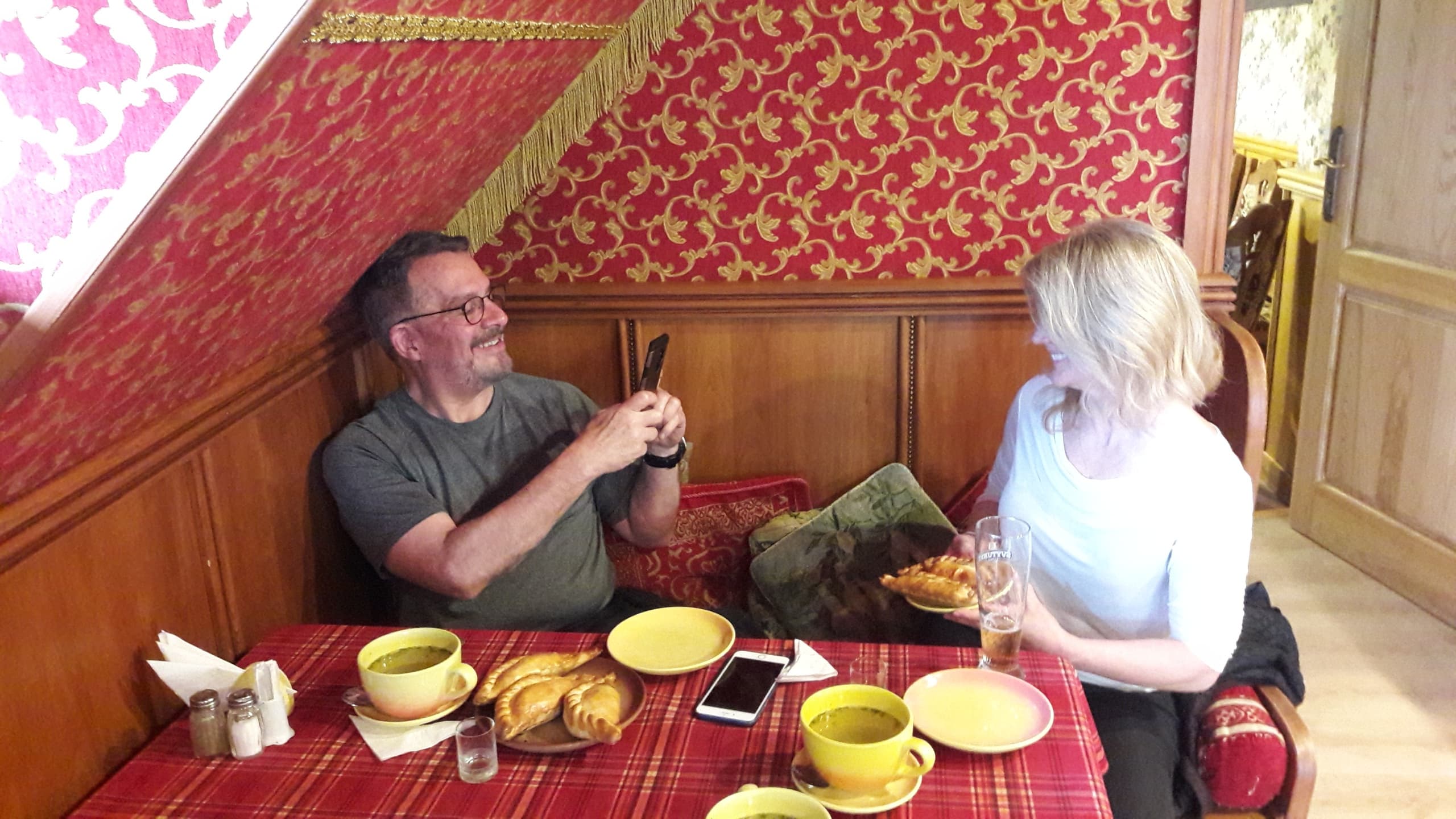 Couple enjoying cozy indoor Baltic cafe and traditional snacks