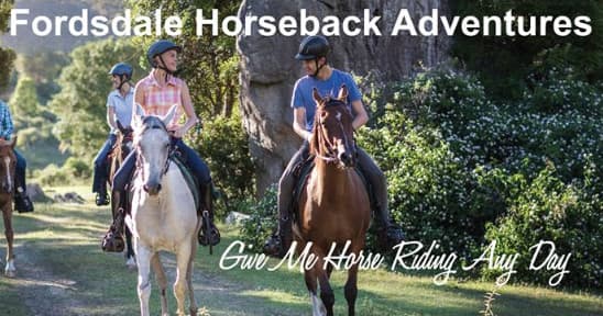 Guided horseback riders on scenic rural trail at Fordsdale farm