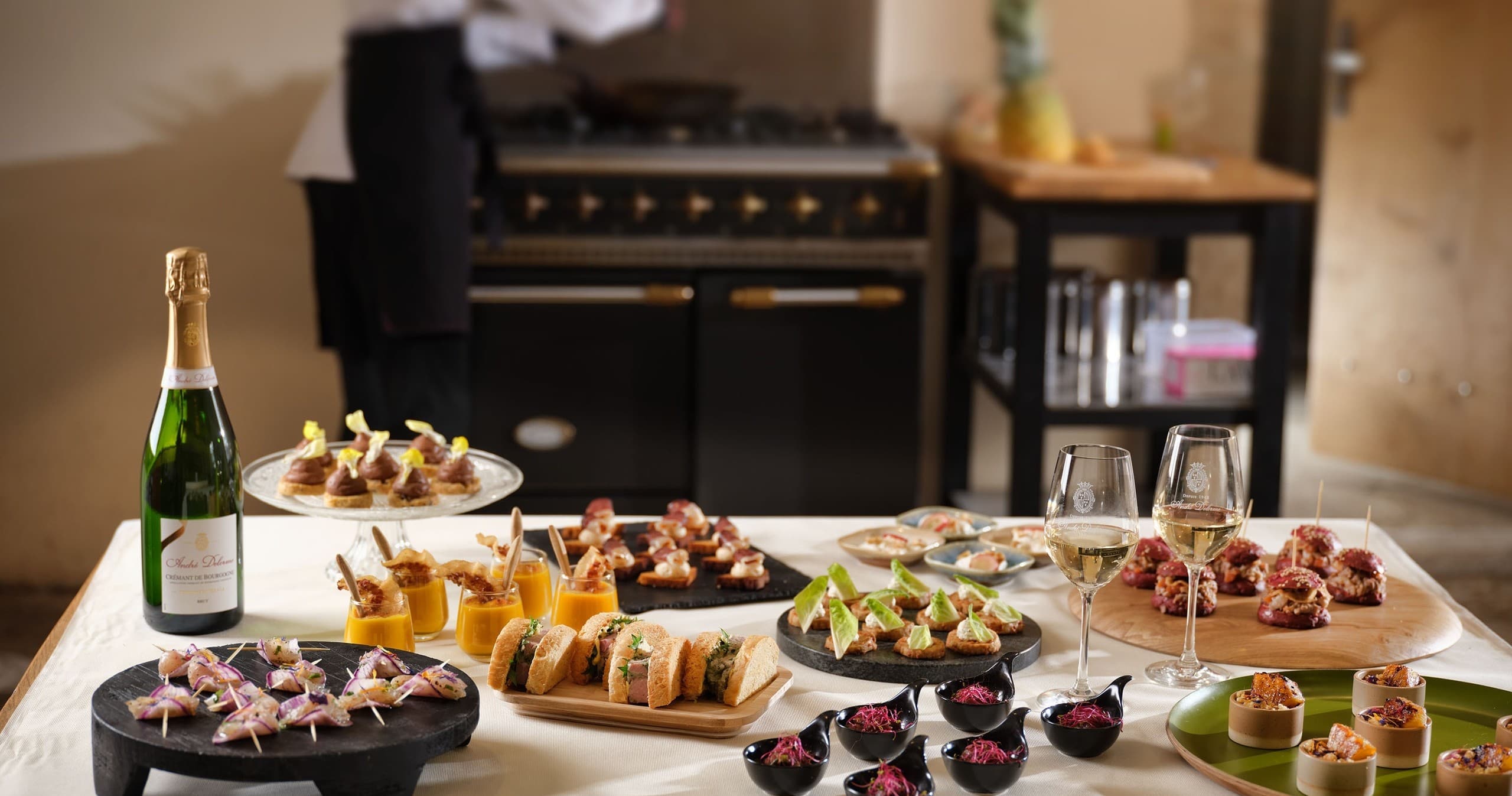 Assorted canapés and champagne on buffet table in event kitchen