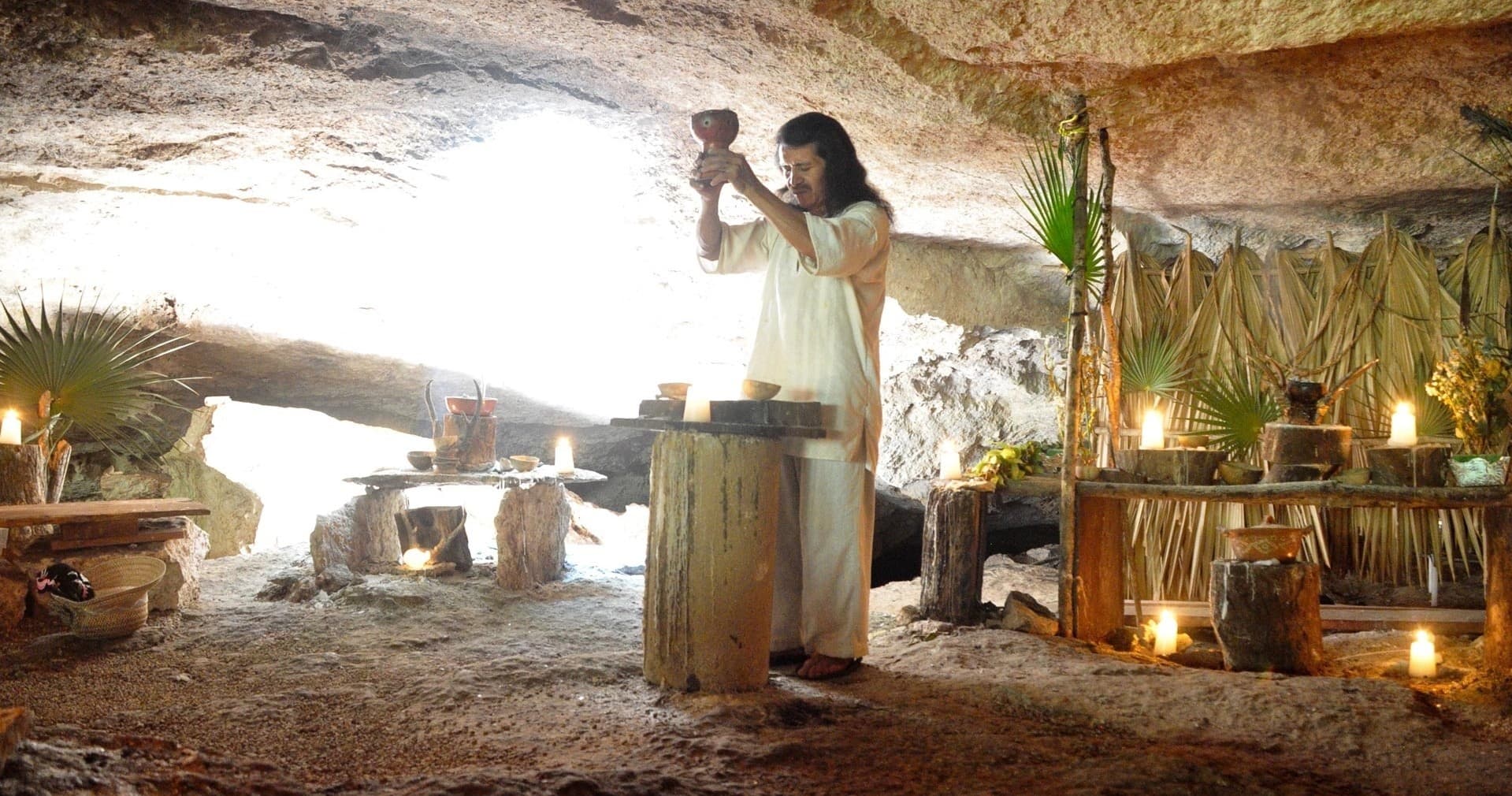 Traditional cave ritual or ceremony inside illuminated rock shelter