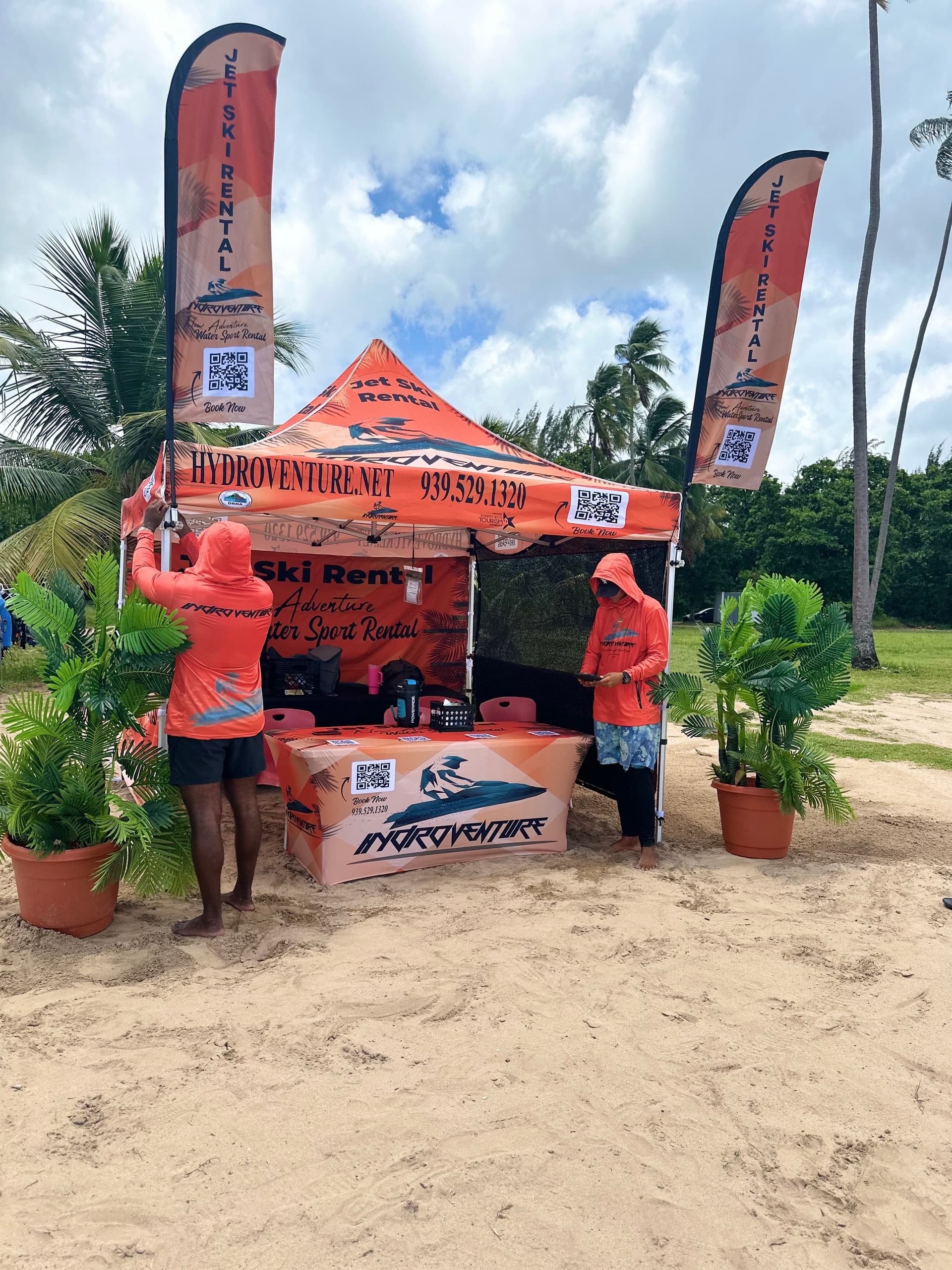 Beach rental kiosk and branded tent offering watersport gear