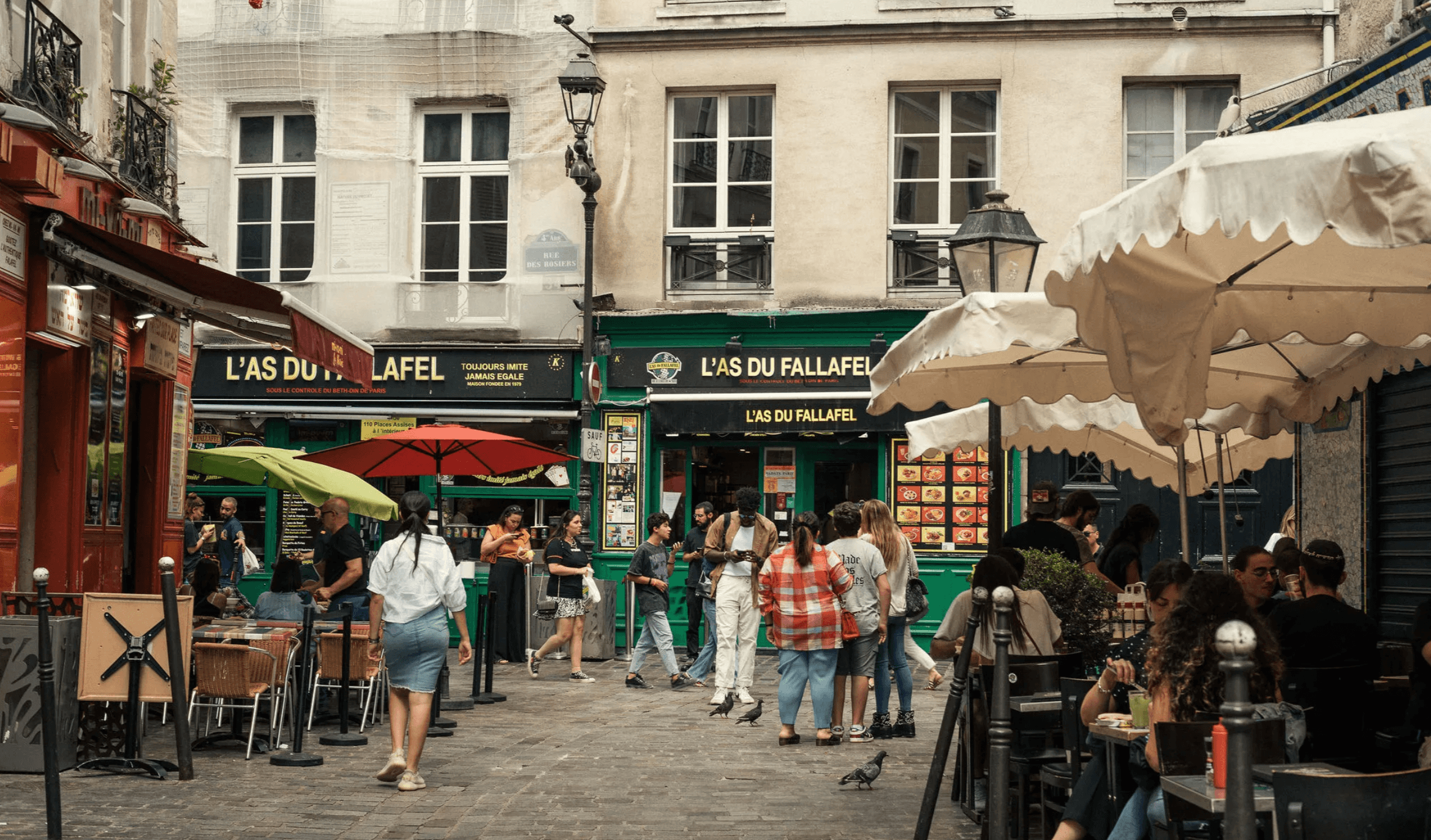 Outdoor cafe and cobblestone street scene with strolling diners in Paris