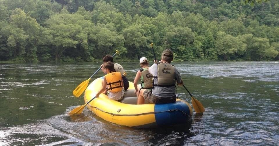 Guides paddling inflatable raft down scenic Hiwassee River current