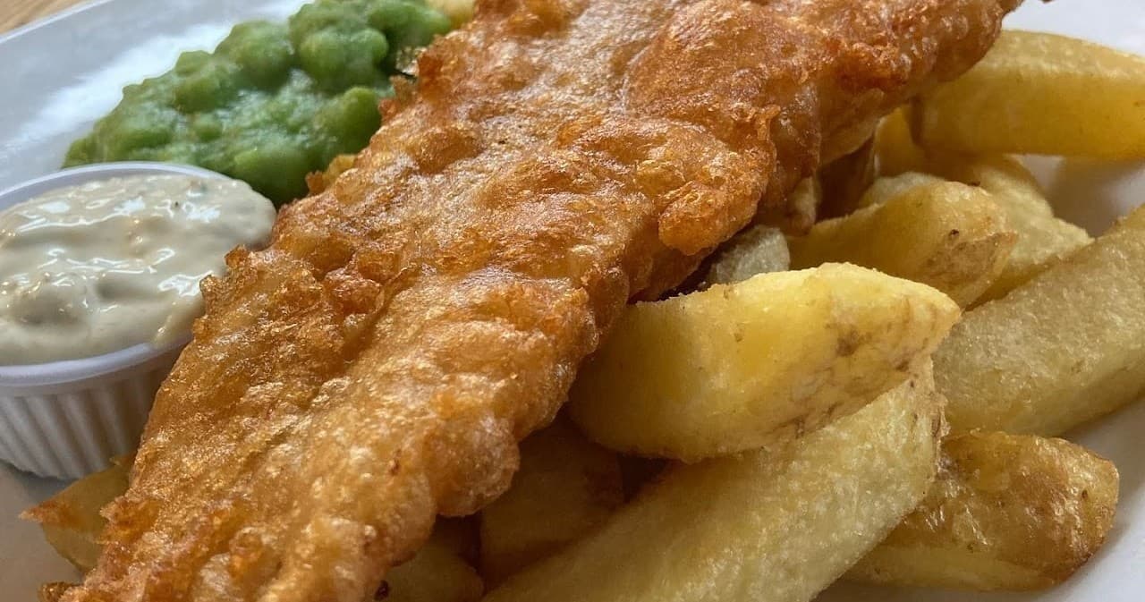 Classic fish and chips with peas and chunky chips on Portsmouth menu