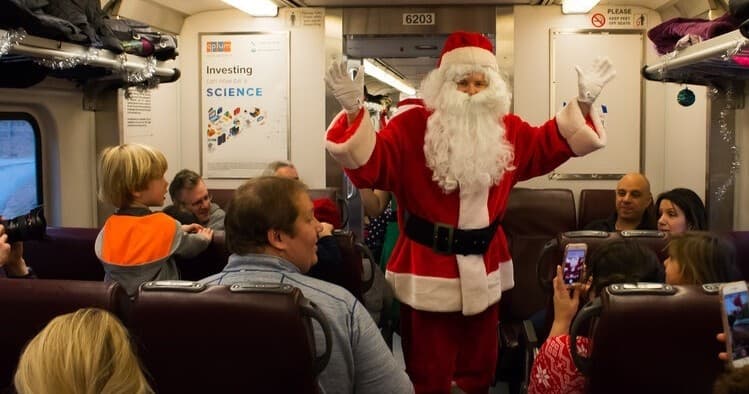 Santa interacting with passengers on a festive holiday train ride
