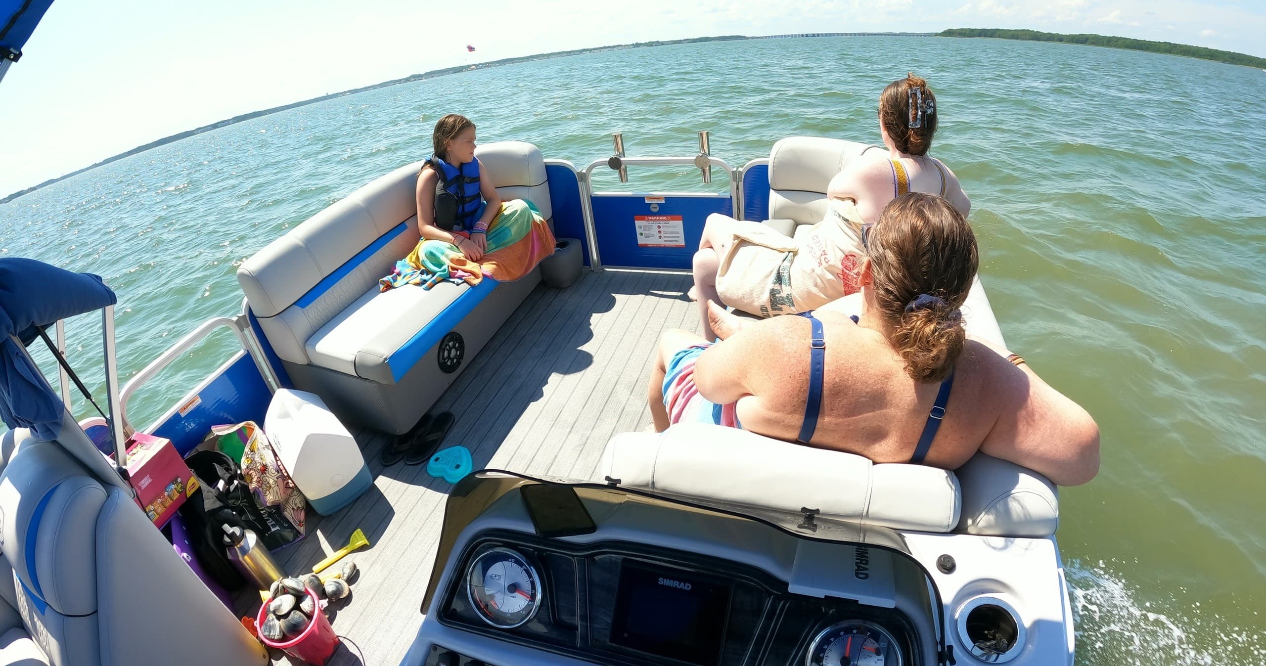 Passengers relaxing on pontoon deck with ocean horizon view