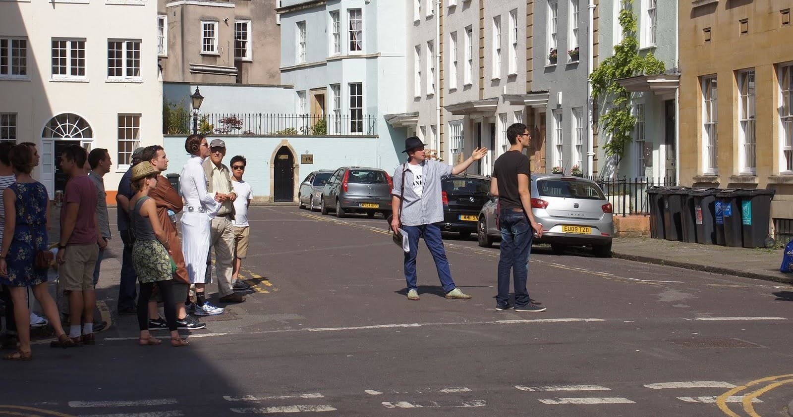 Small walking tour gathering on quiet urban residential street