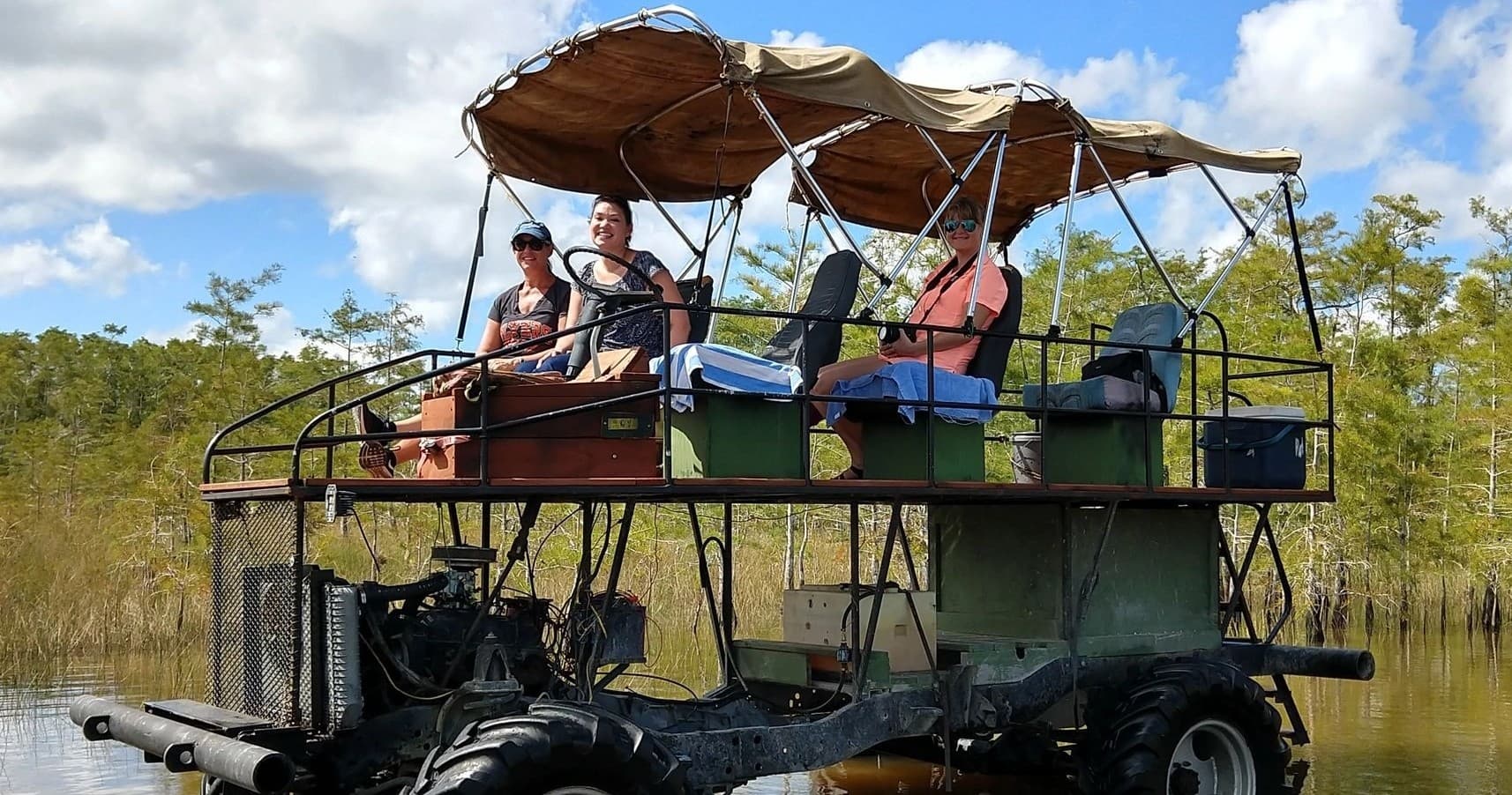 Passengers on airboat cruising Big Cypress swamp waters