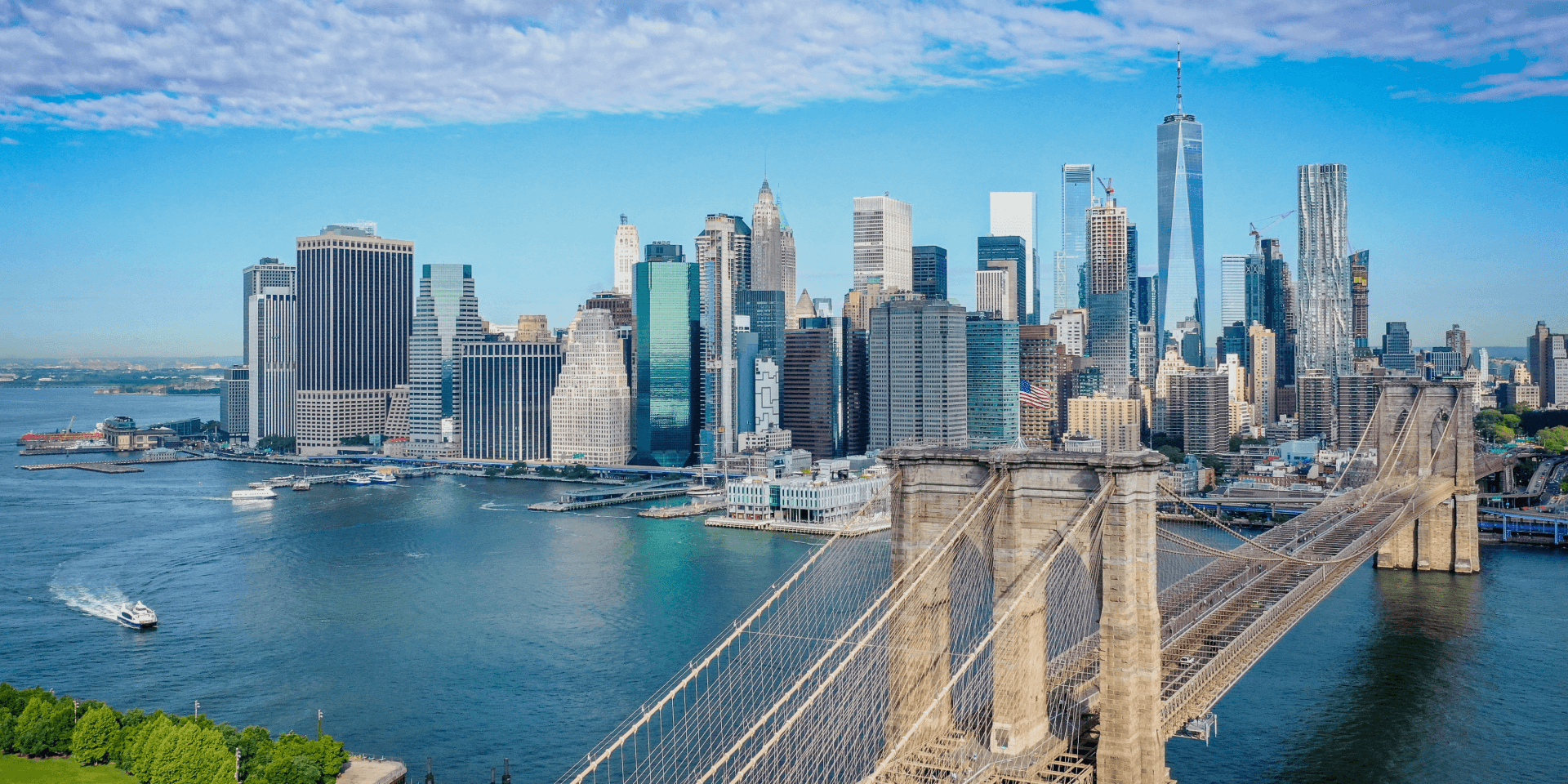 Brooklyn Bridge and Manhattan skyline over East River, waterfront view