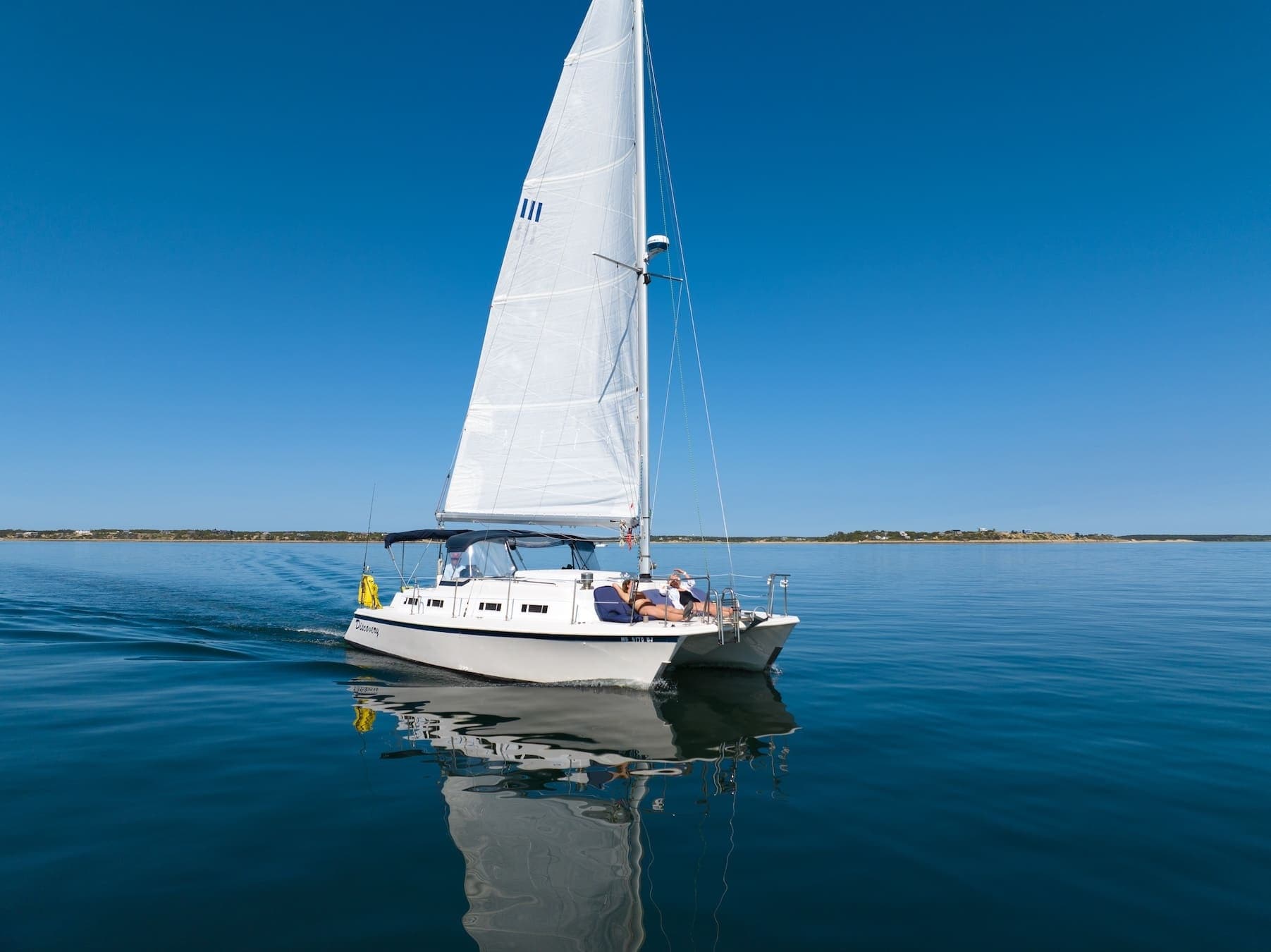 Catamaran sailing on calm blue waters off Cape Cod coast