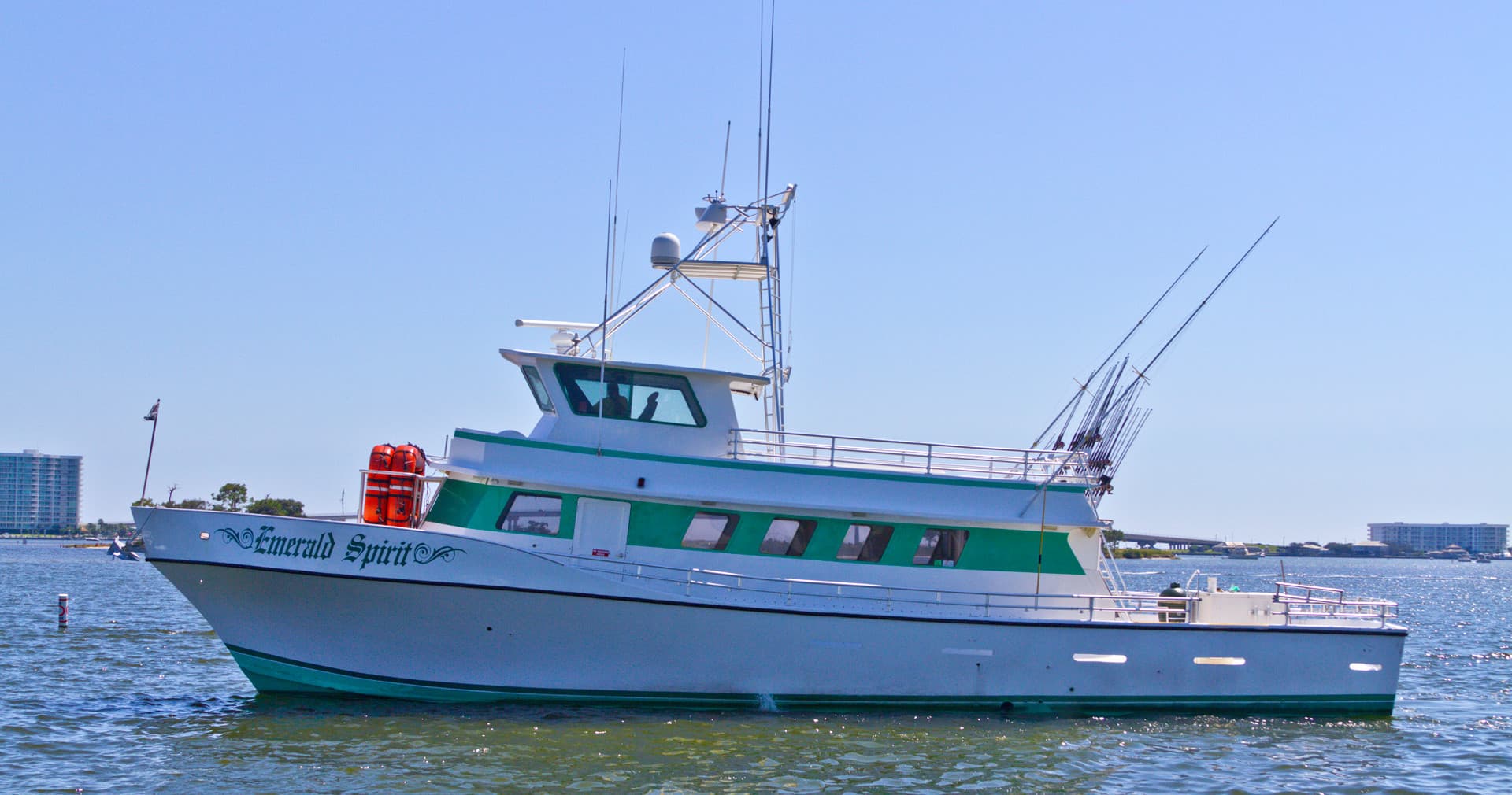 Fishing charter boat cruising in coastal waters, scenic offshore view