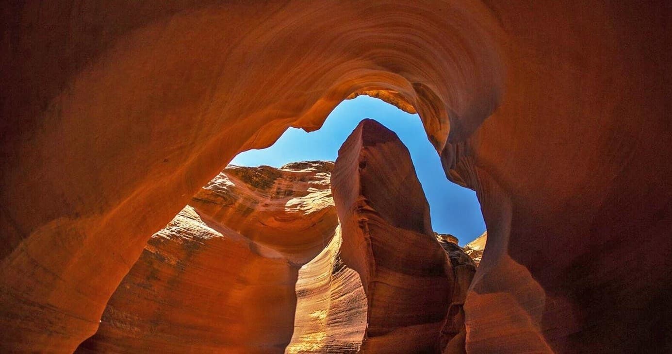 Sandstone arch slot canyon entrance viewed during hiking