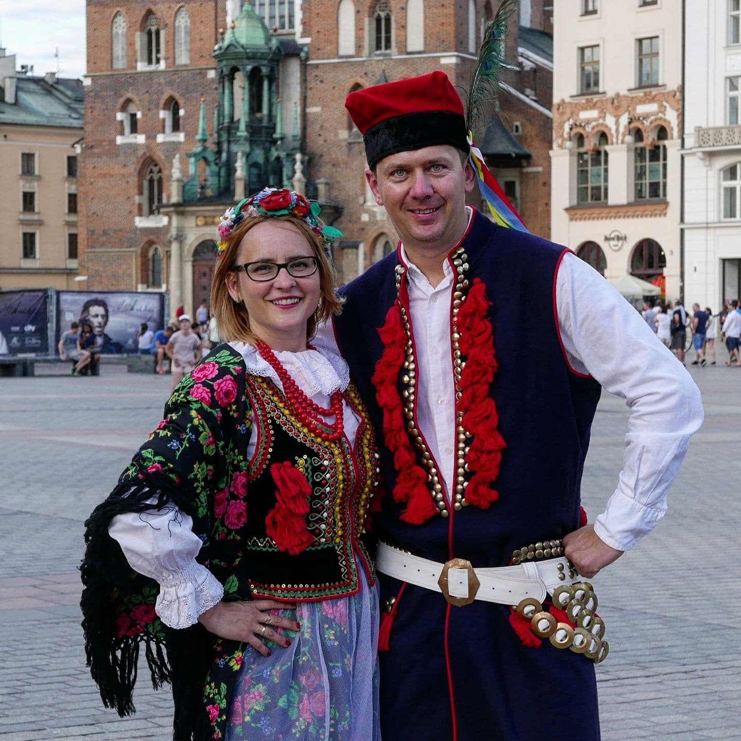 Locals in traditional Polish folk costume at Krakow square