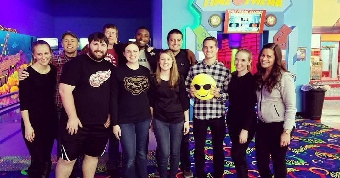Friends group photo at indoor family entertainment center arcade