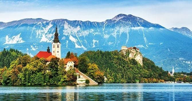 Island church on alpine lake with mountain vistas, Slovenia