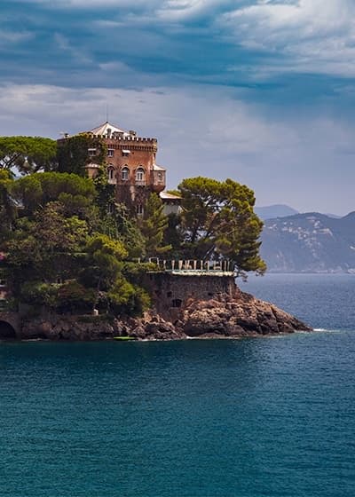Seaside villa on rugged promontory overlooking open sea, scenic stop