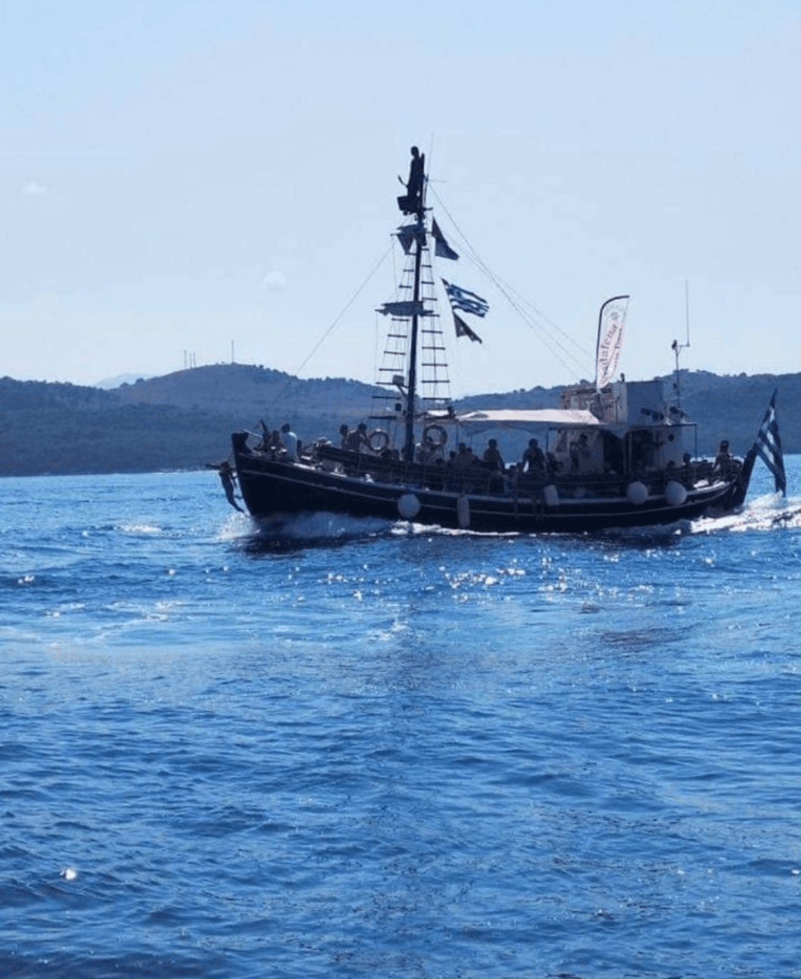 Tour boat cruising open blue sea under sunny coastal skies