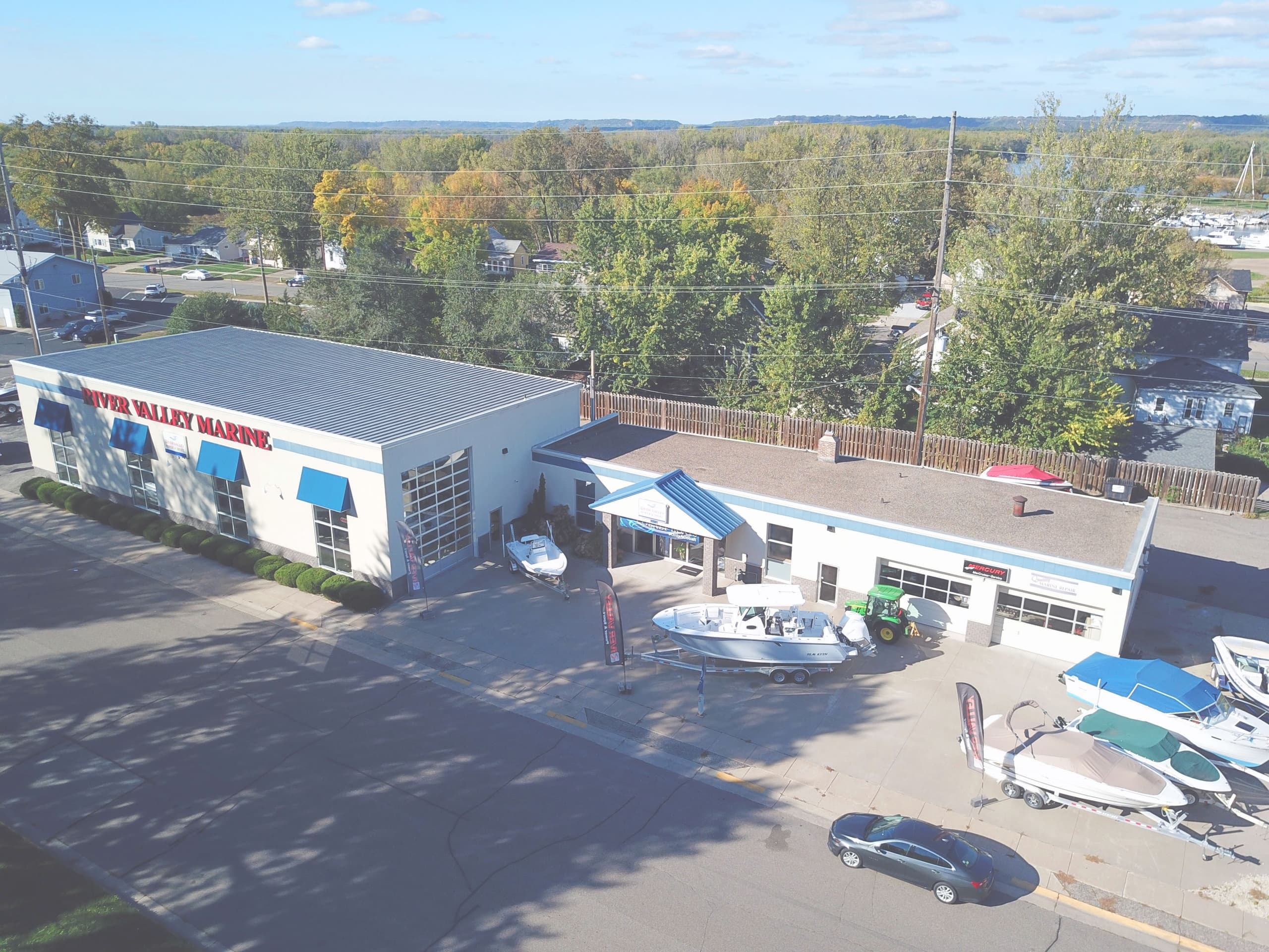 Aerial view of marine dealership lot with boats and service bays