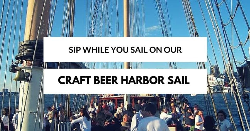 Passengers enjoying a craft beer harbor sail with NYC skyline views