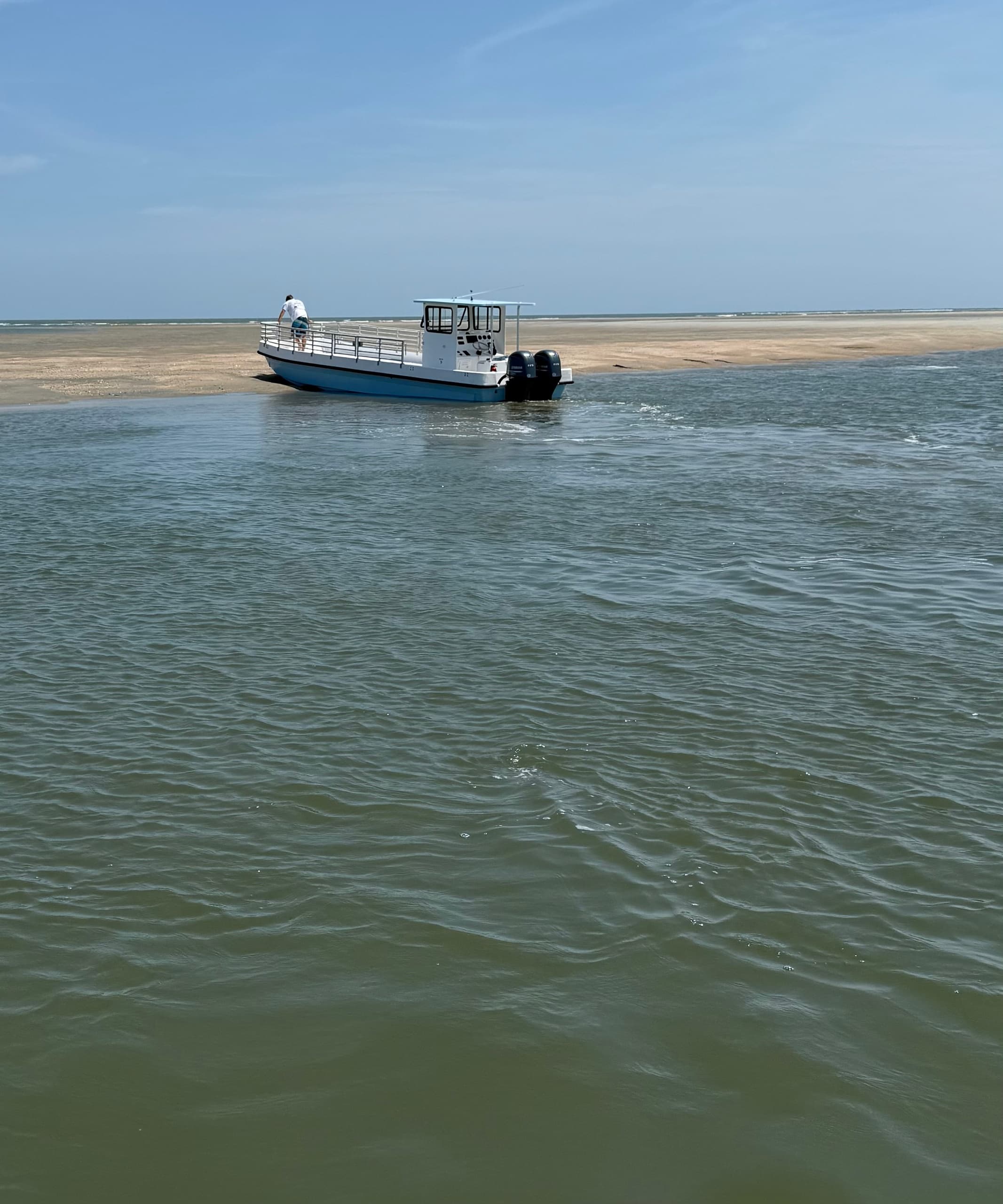 Shallow water boat approaching sandbar on coastal eco tour