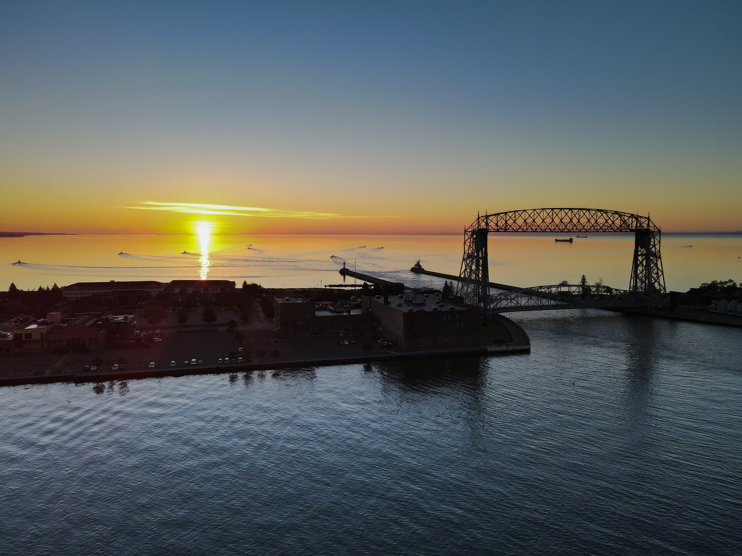 Sunset over channel with iconic aerial lift bridge silhouette