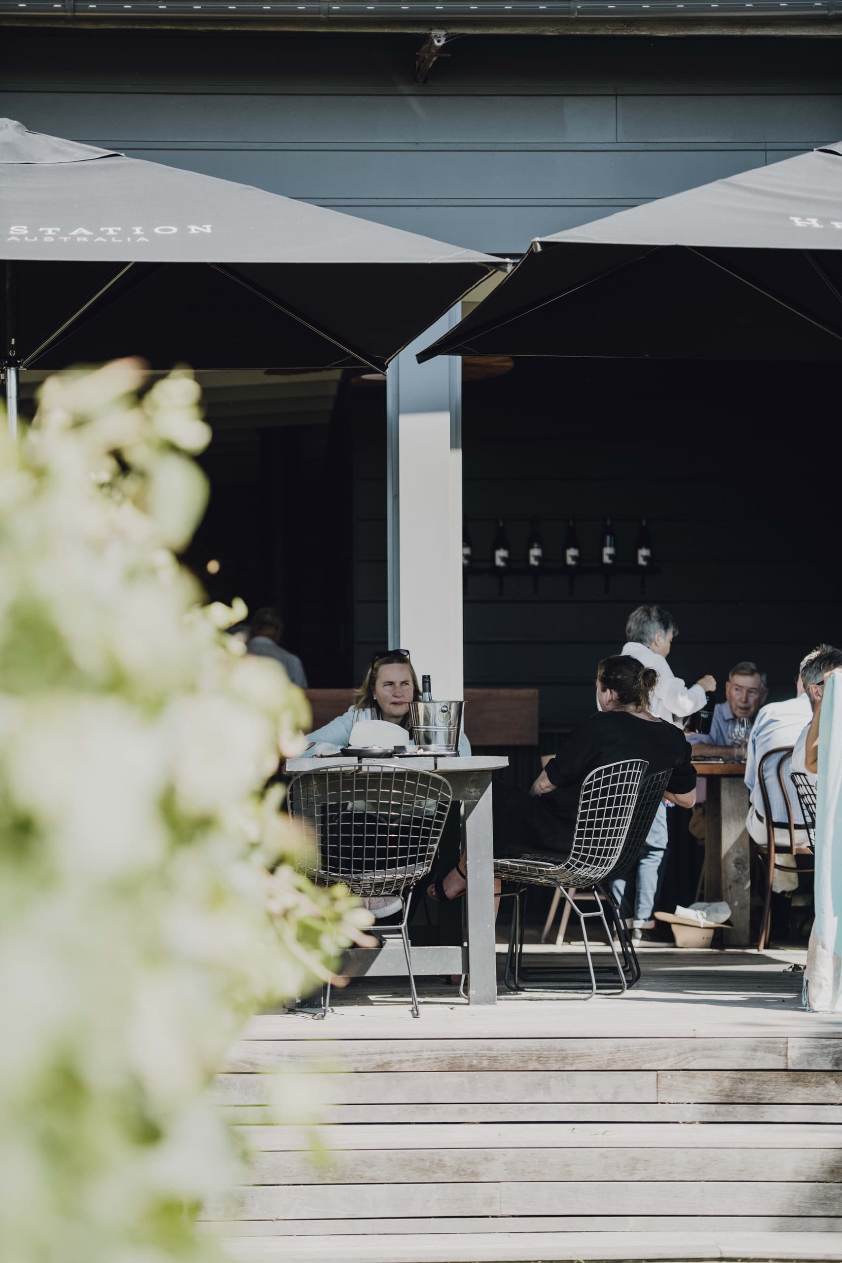 Patrons dining on outdoor café terrace with farm views at Heifer