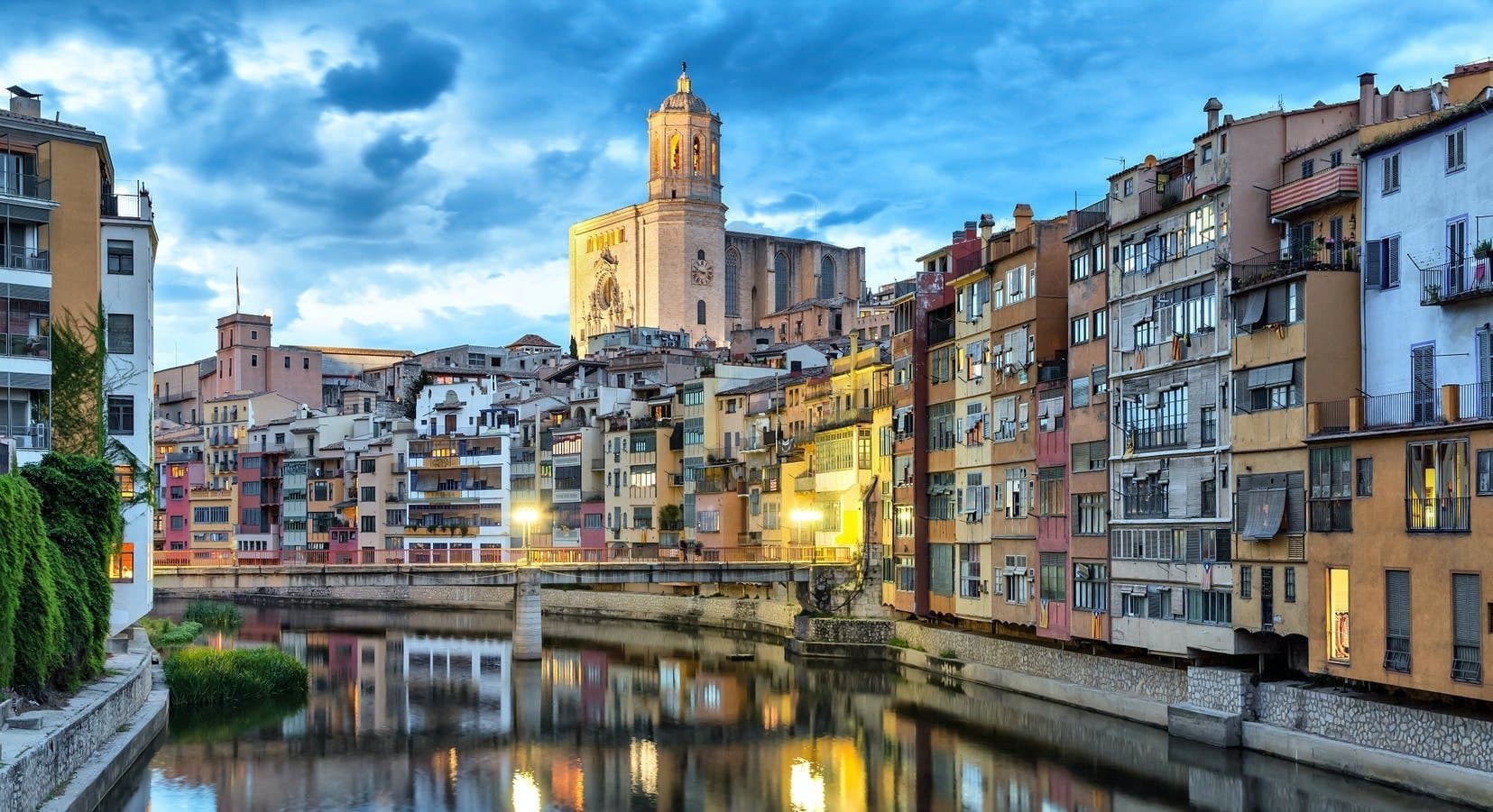 Evening Onyar River skyline with historic cathedral and bridge