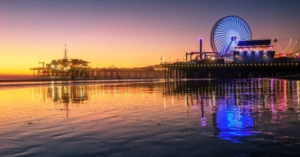 Sunset Ferris wheel and pier reflecting on Pacific Beach, California