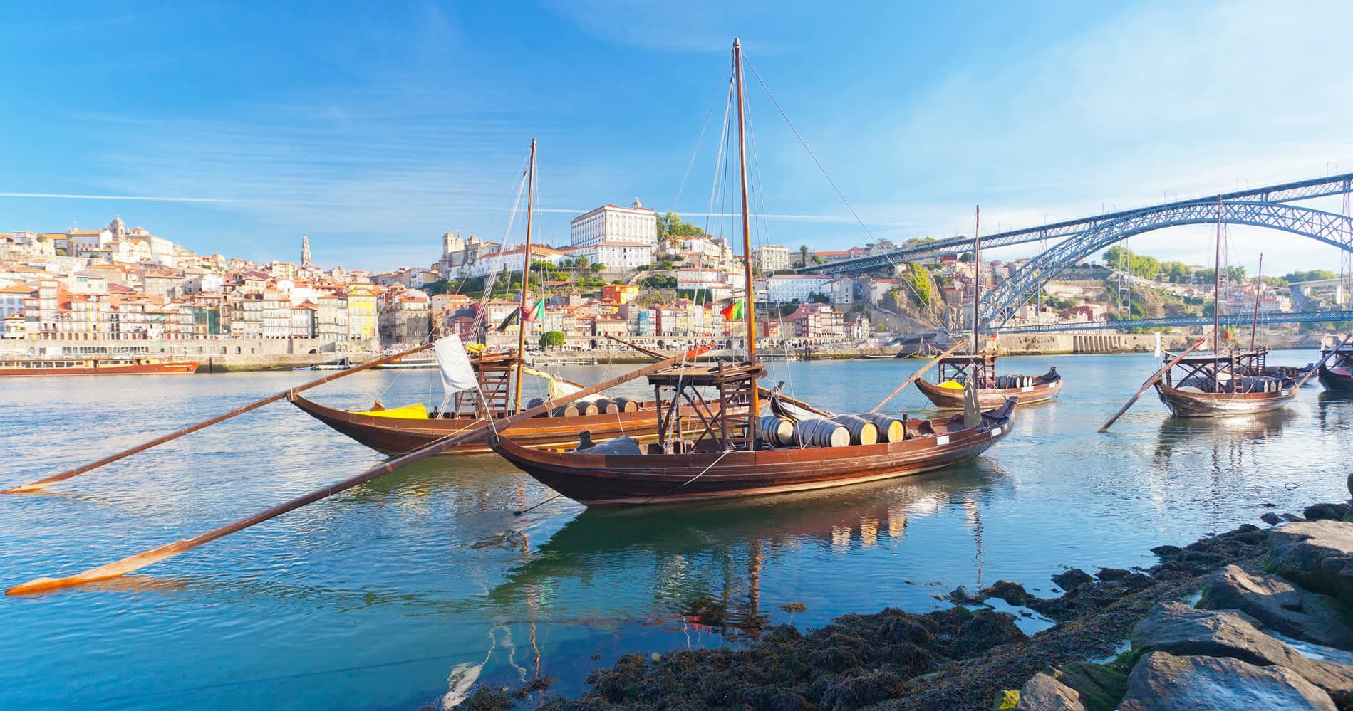 Historic rabelo boats moored on Porto waterfront at sunrise