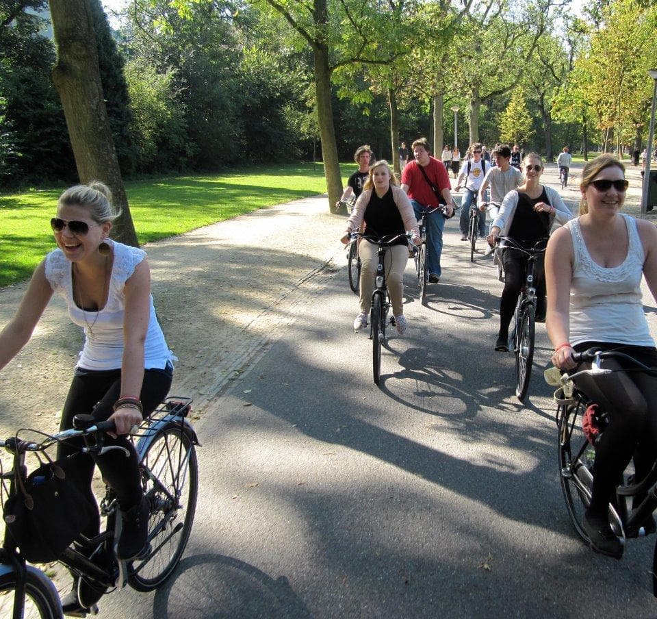 Guided bike tour on tree-lined park paths showcasing outdoor riding