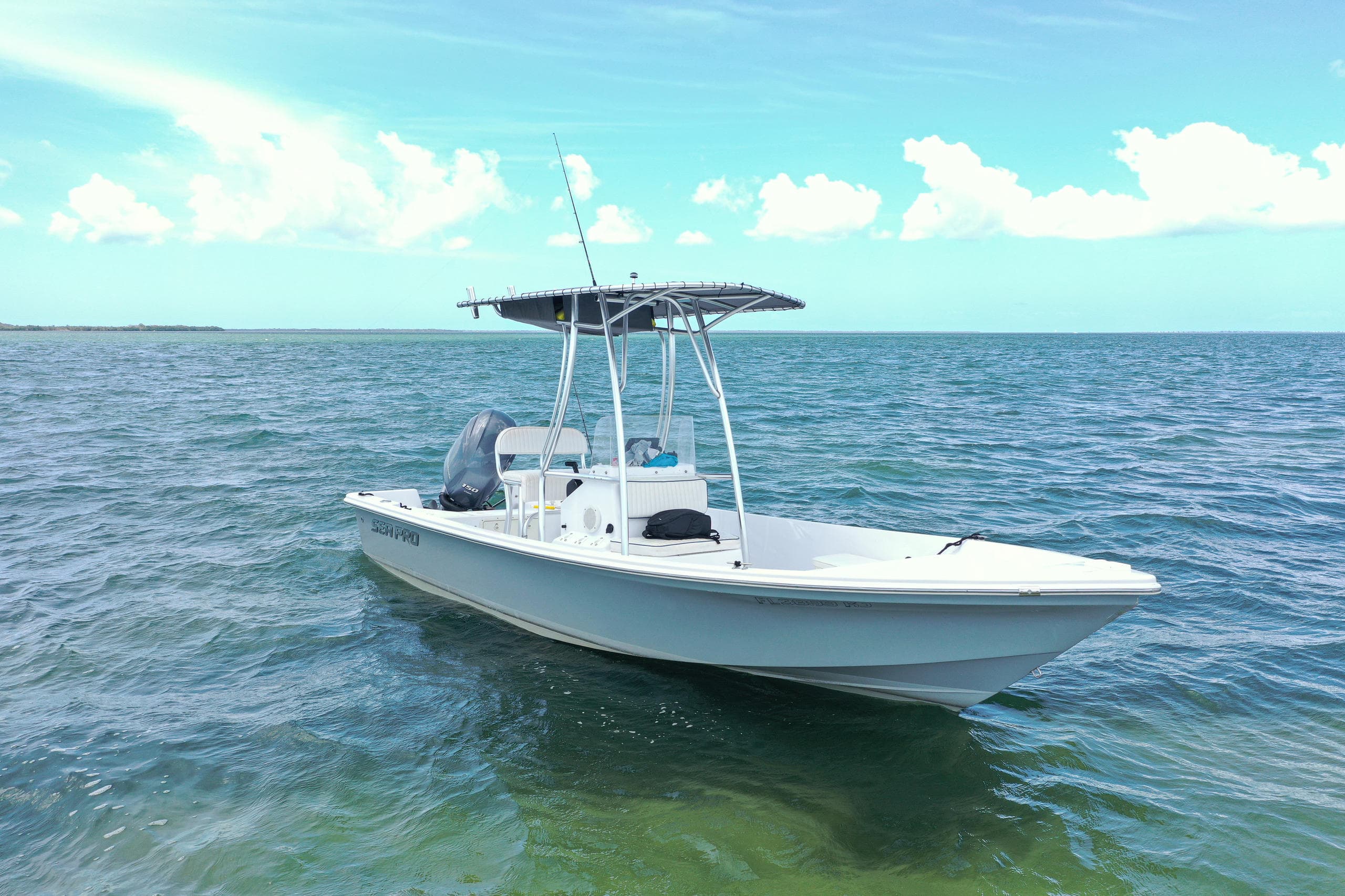 Offshore center-console boat exploring open coastal water for fishing