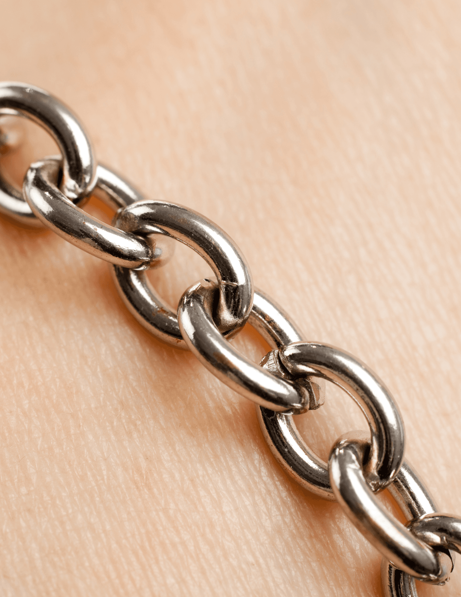 Close-up metal chain necklace detail on skin, macro jewelry shot