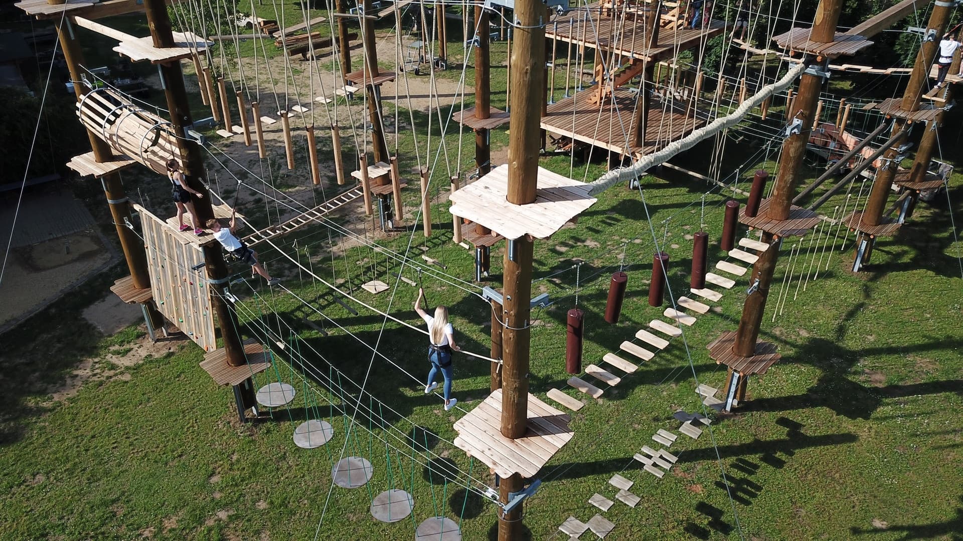 Aerial view of multi-level adventure ropes course over lawn