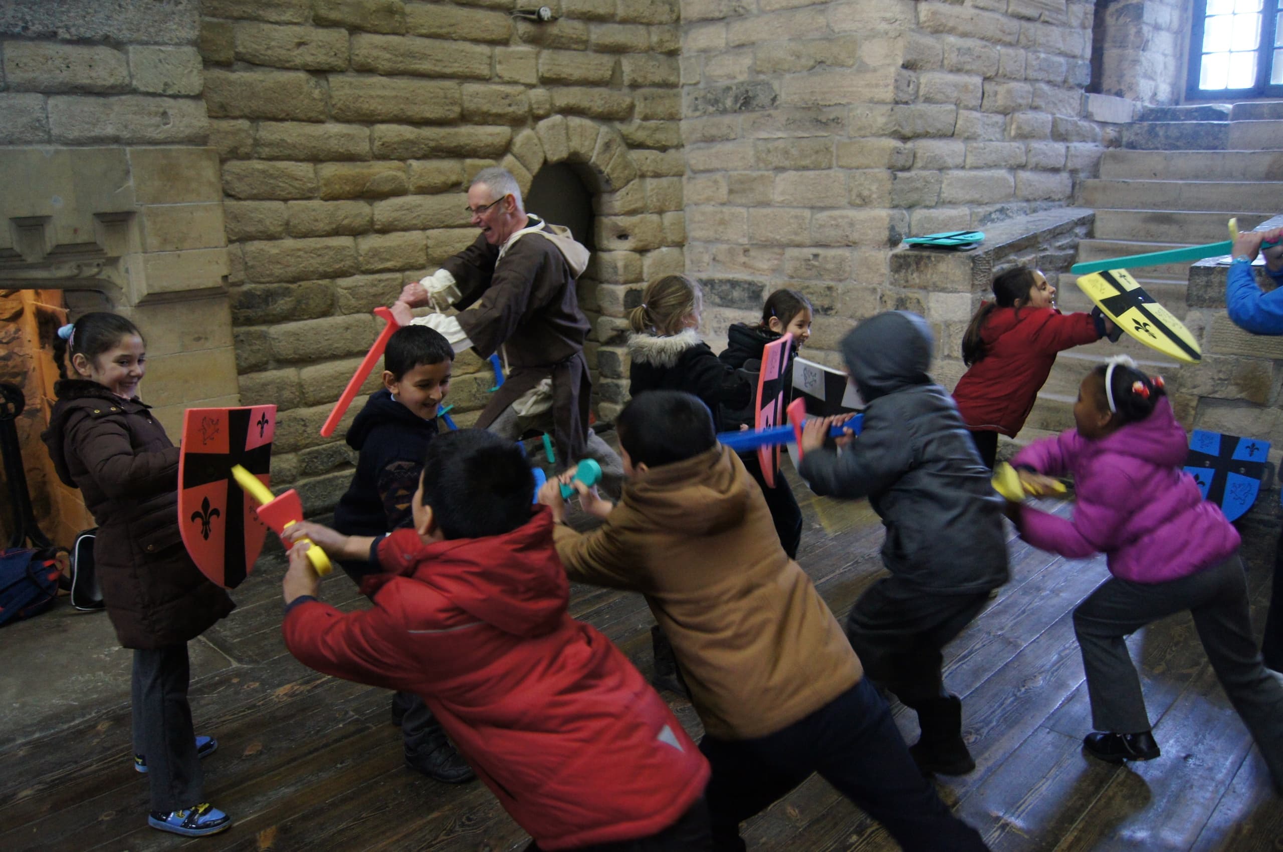 Children in medieval knights activity inside historic Newcastle castle