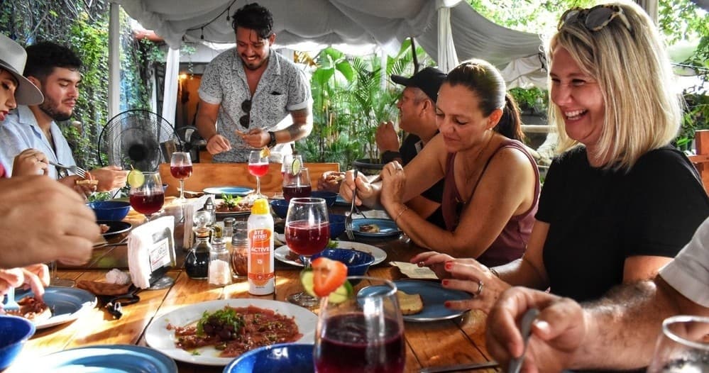 Alfresco group dining together at a seaside table in Vallarta