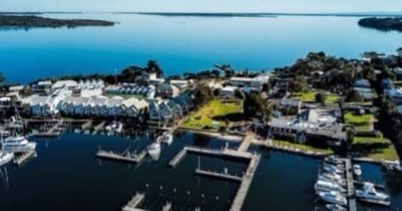 Marina aerial view of boats and waterfront town on lakeshore