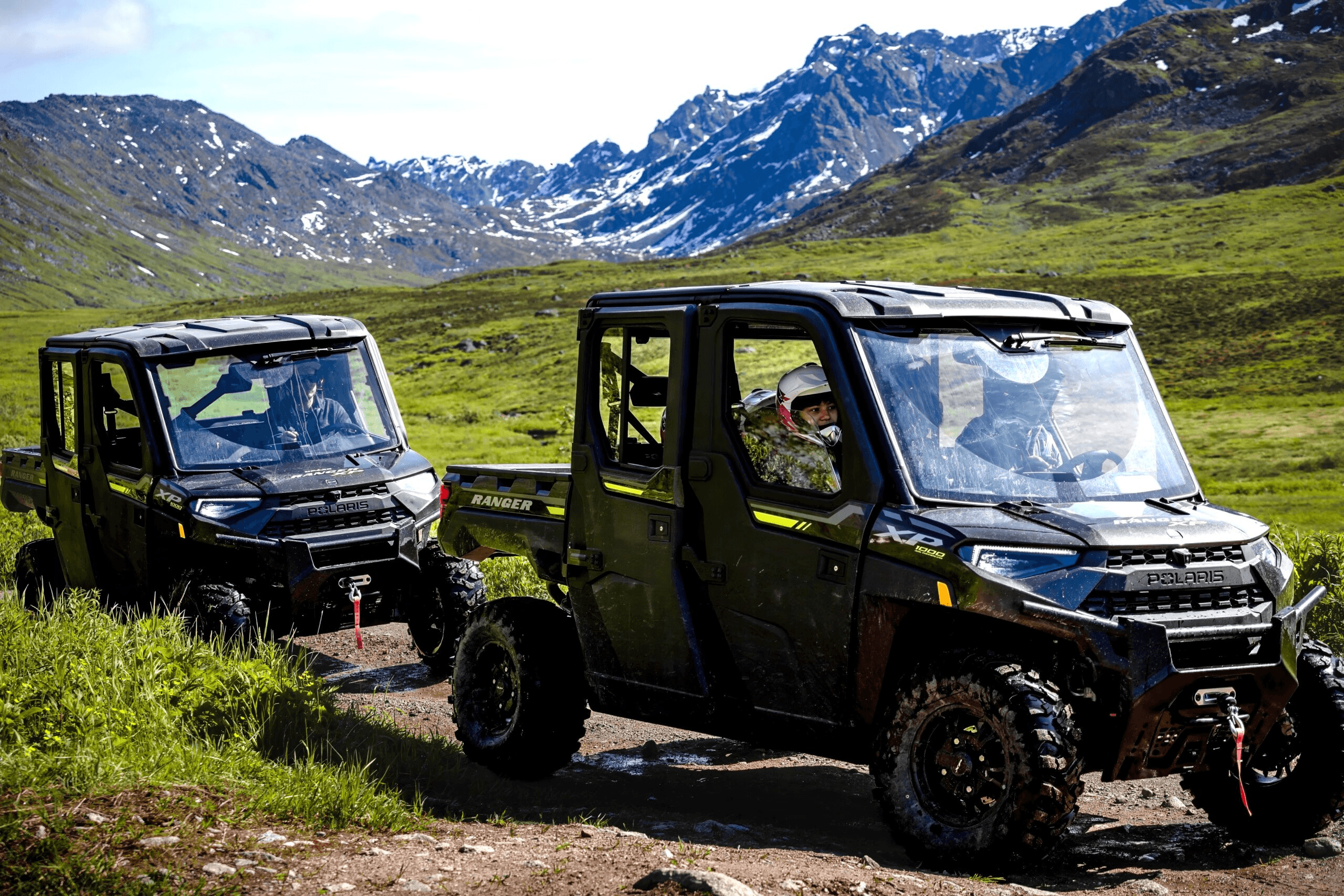 Two UTVs parked on alpine meadow for off-road adventure