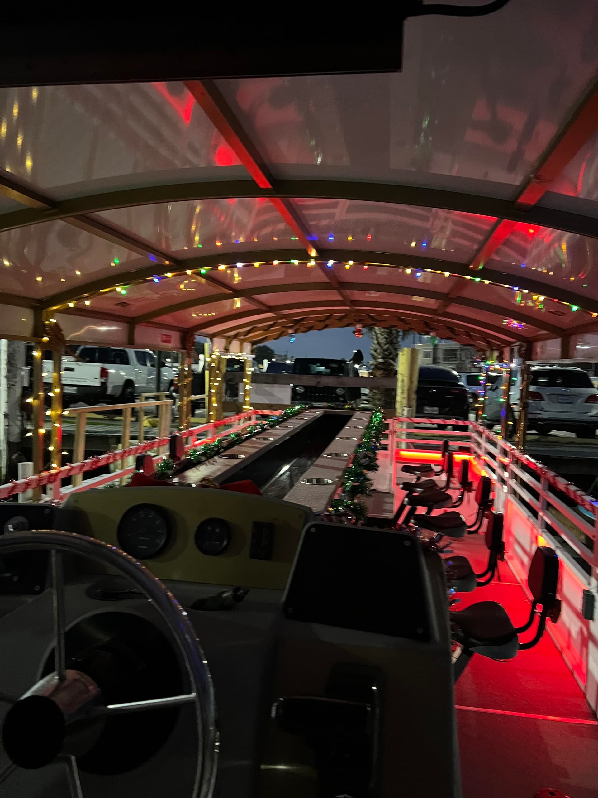 Decorated pedal barge interior with neon lights at dock