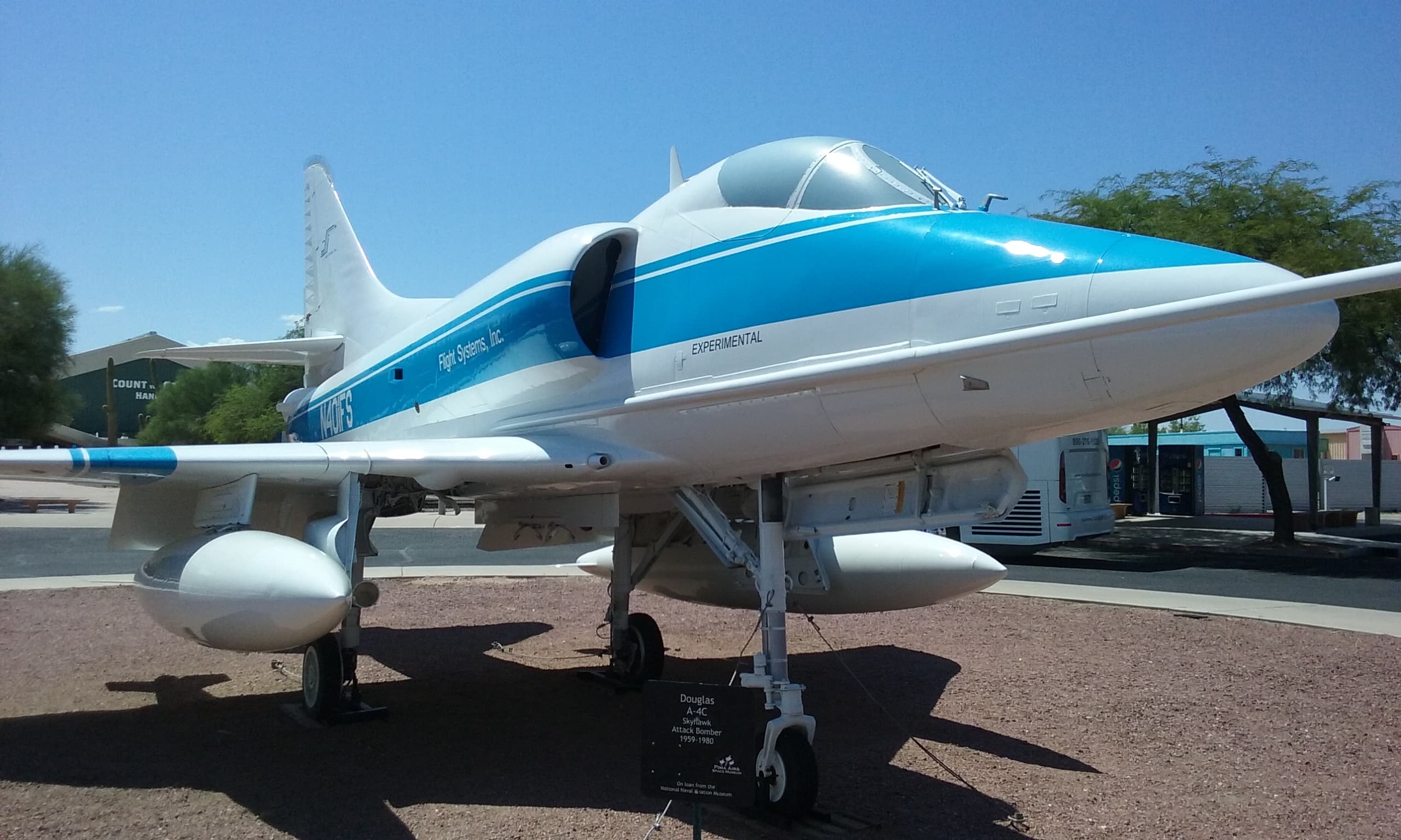Light blue business jet displayed on sunny Arizona airfield