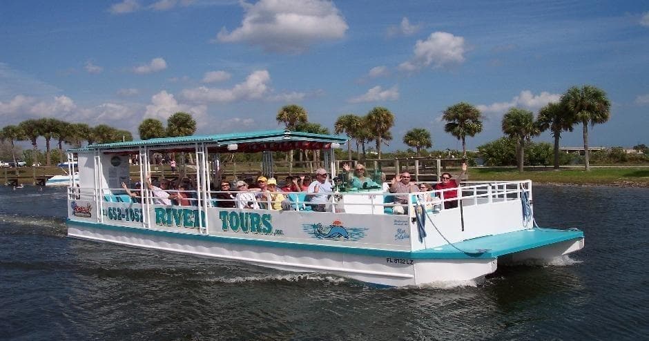 Guided river tour boat with passengers cruising Space Coast waterways