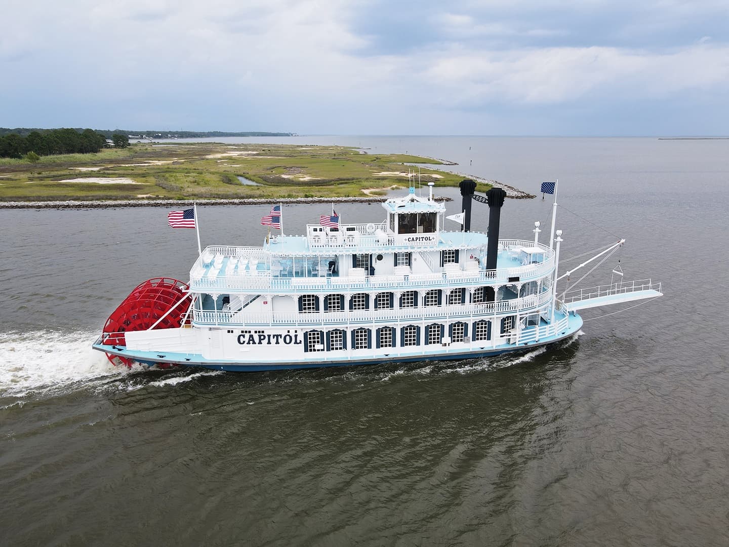Paddlewheel riverboat cruising near Nashville marshy riverbanks