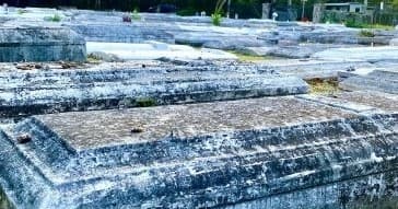 Ancient stone ruins and raised burial slabs at outdoor site