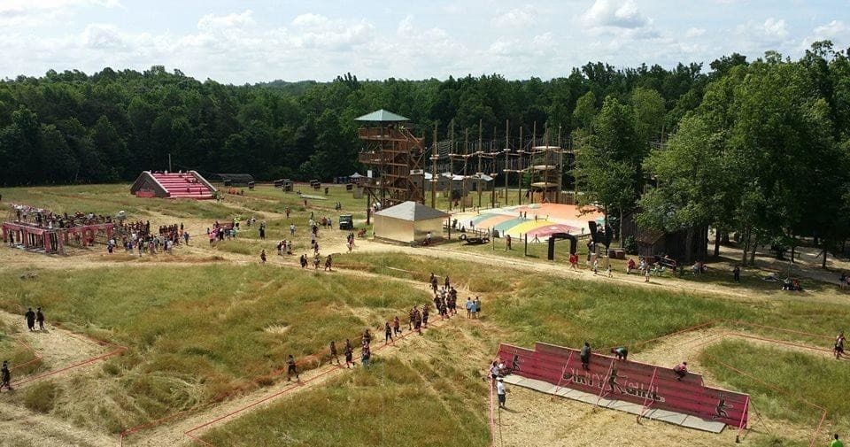 Aerial view of outdoor adventure park with ziplines and trails