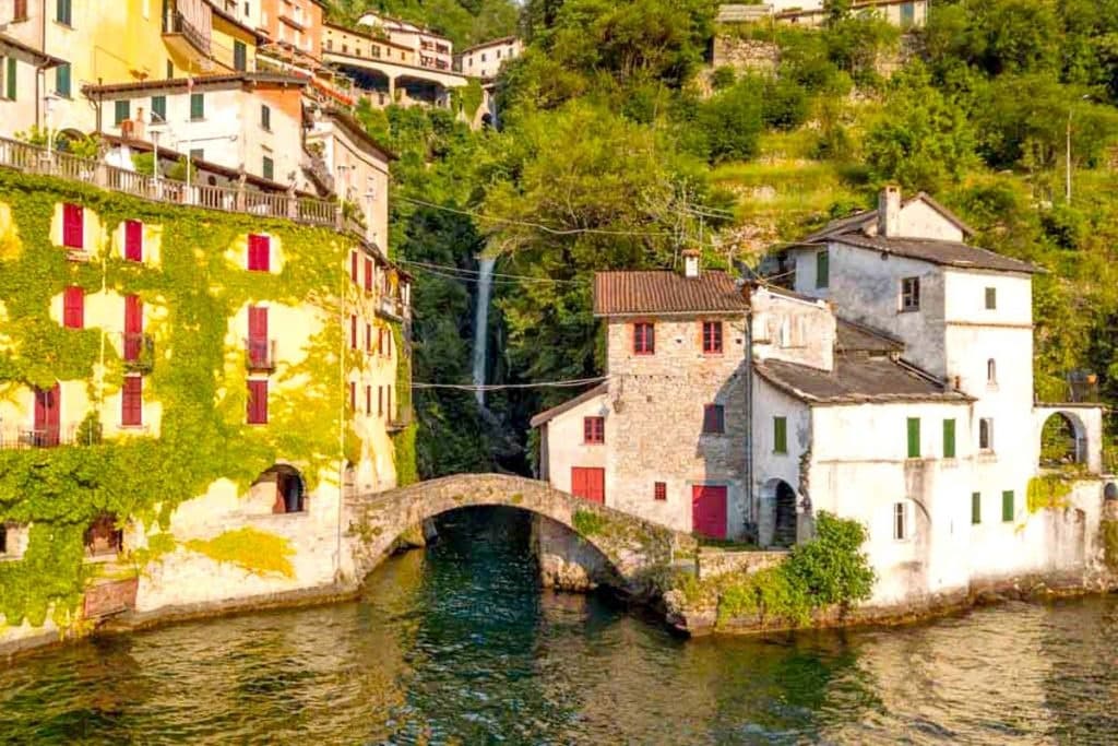 Historic lakeside village with stone bridge on Lake Como shore