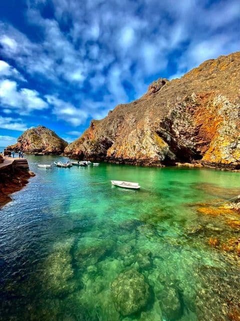 Crystal clear turquoise bay with small boat in Berlenga inlet