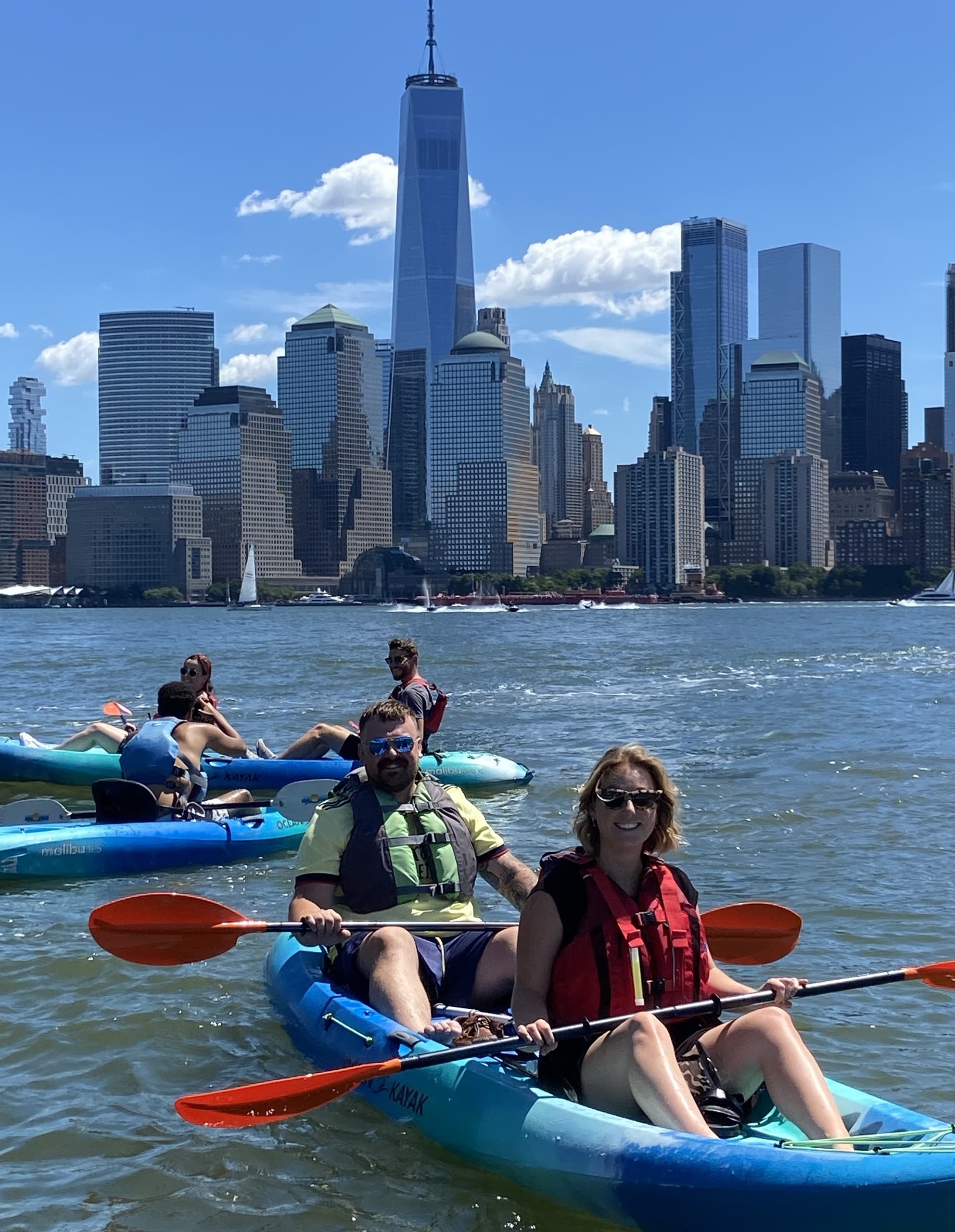 Group kayaking with Manhattan skyline backdrop on Hudson River